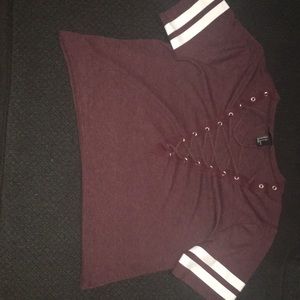 This is a Shirt with a crisscross V-neck line.